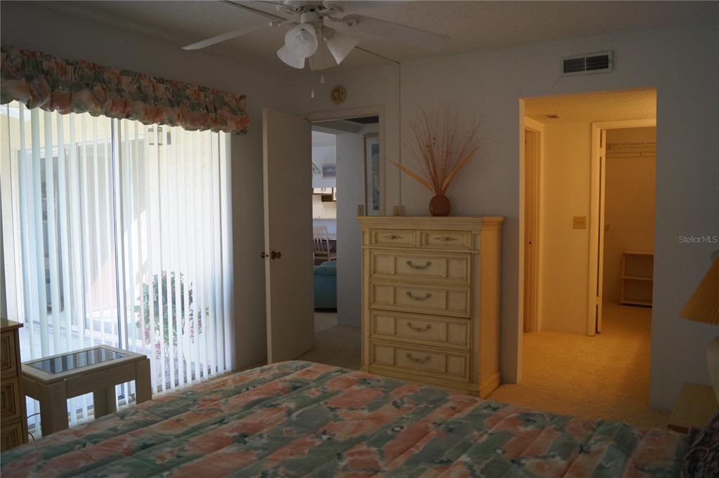 7701 Starkey Road, Unit 408 Seminole, FL 33777 - Photo 22 of 28 a view of a bedroom with a dresser and chandelier
