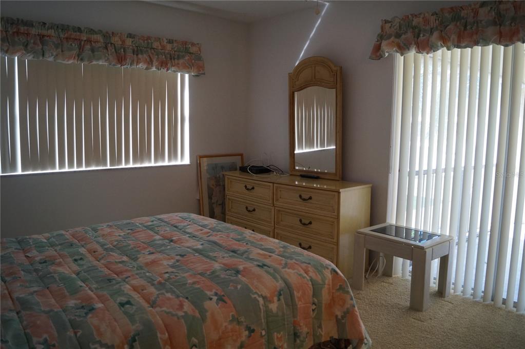7701 Starkey Road, Unit 408 Seminole, FL 33777 - Photo 23 of 28 a bedroom with a bed and a window