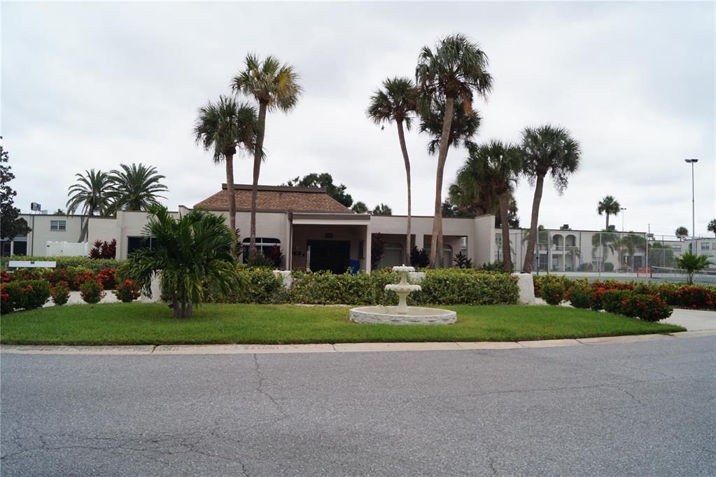 7701 Starkey Road, Unit 408 Seminole, FL 33777 - Photo 4 of 28 a front view of a house with a garden and trees