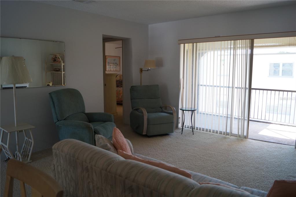 7701 Starkey Road, Unit 408 Seminole, FL 33777 - Photo 8 of 28 a living room with furniture and a large window