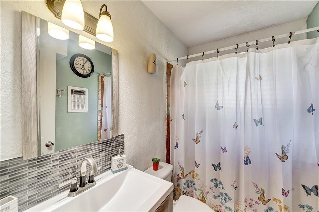 712 Ridgecrest Drive Lewisville, TX 75067 - Photo 11 of 12 a bathroom with a sink and a mirror