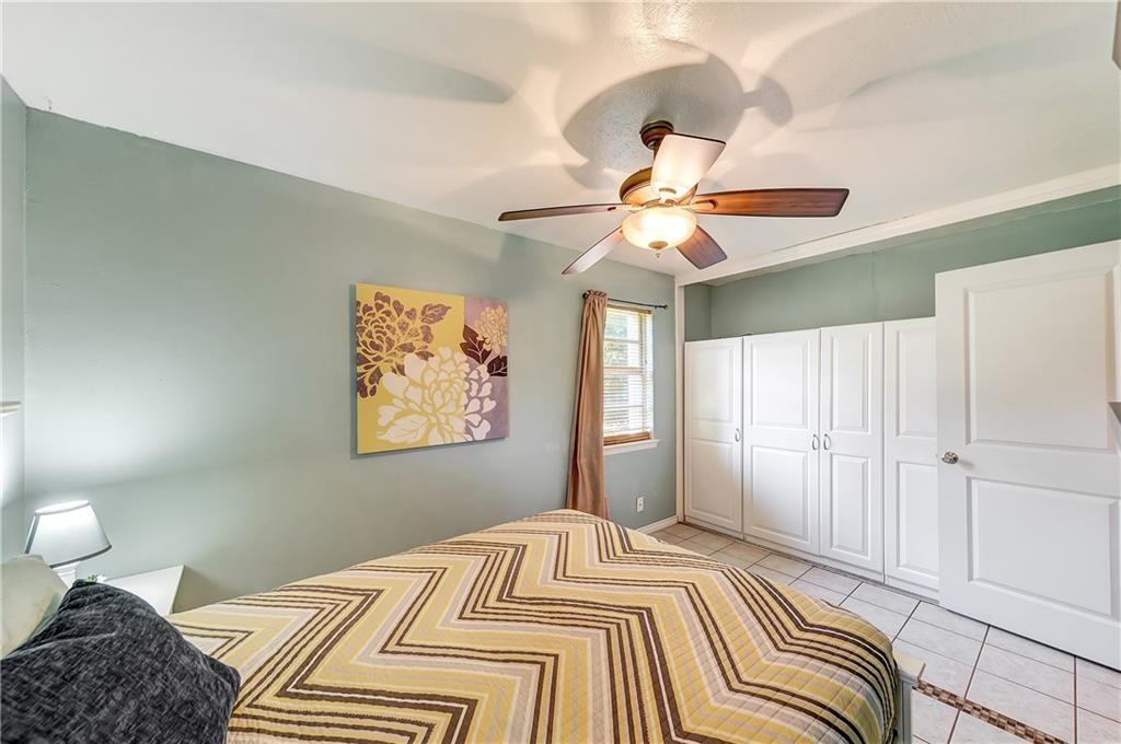 712 Ridgecrest Drive Lewisville, TX 75067 - Photo 8 of 12 a bedroom with a bed and a chandelier