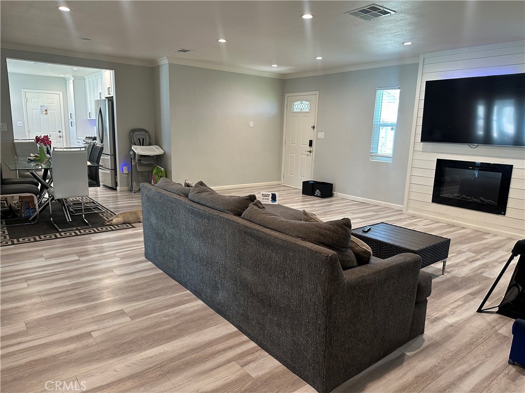 114 South Acacia Avenue Rialto, CA 92376 - Photo 5 of 27 another view family room and fireplace