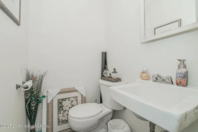 a white toilet sitting next to a bathroom sink