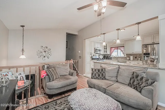 a living room with furniture and kitchen view