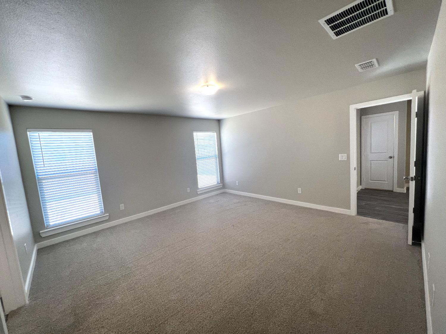 13705 Avenue Q Lubbock, TX 79423 - Photo 12 of 13 an empty room with windows and closet