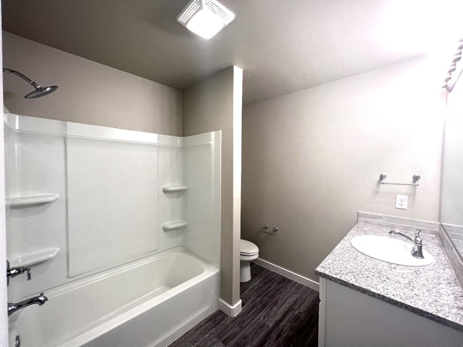 13705 Avenue Q Lubbock, TX 79423 - Photo 13 of 13 a bathroom with a granite countertop sink and a mirror