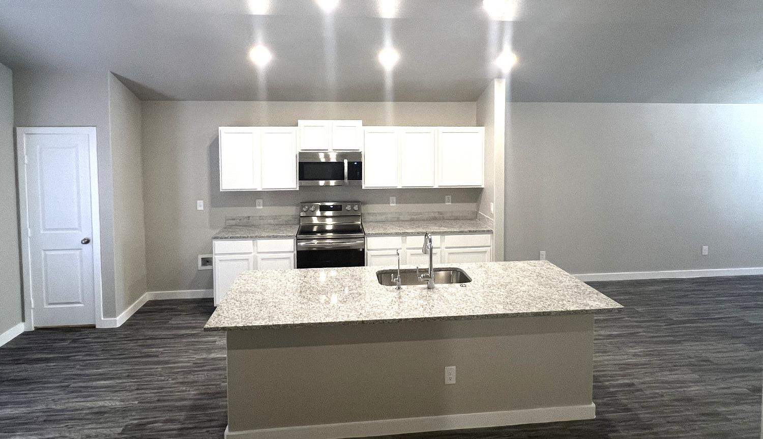 13705 Avenue Q Lubbock, TX 79423 - Photo 6 of 13 a kitchen with kitchen island stainless steel appliances a sink and a window