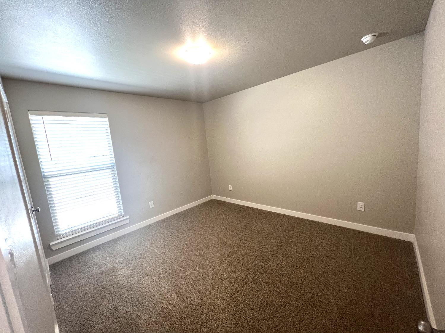 13705 Avenue Q Lubbock, TX 79423 - Photo 8 of 13 an empty room with a window
