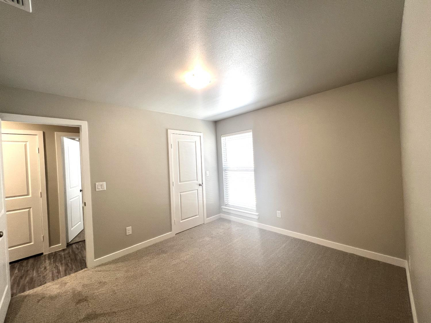 13705 Avenue Q Lubbock, TX 79423 - Photo 9 of 13 an empty room with windows and closet