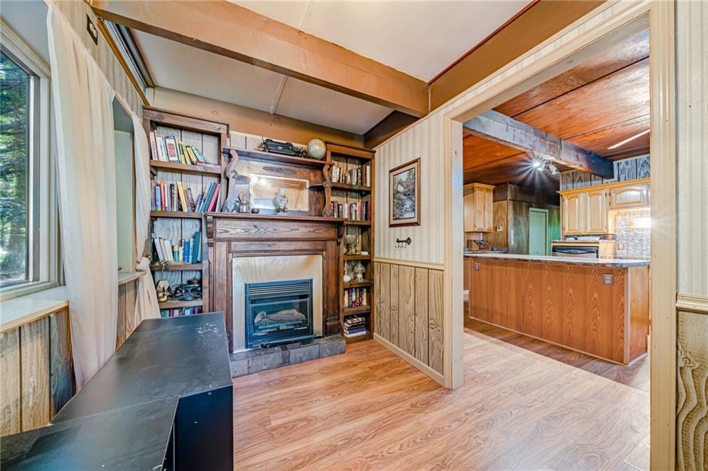 218 Horse Shoe Bend Road Acme, PA 15610 - Photo 11 of 31 a view of an empty room with wooden floor and a fireplace