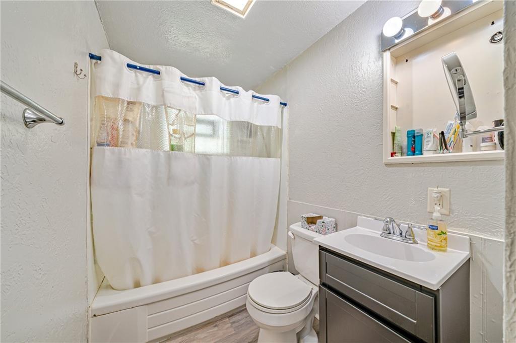 218 Horse Shoe Bend Road Acme, PA 15610 - Photo 19 of 31 a bathroom with a sink a toilet and shower curtain