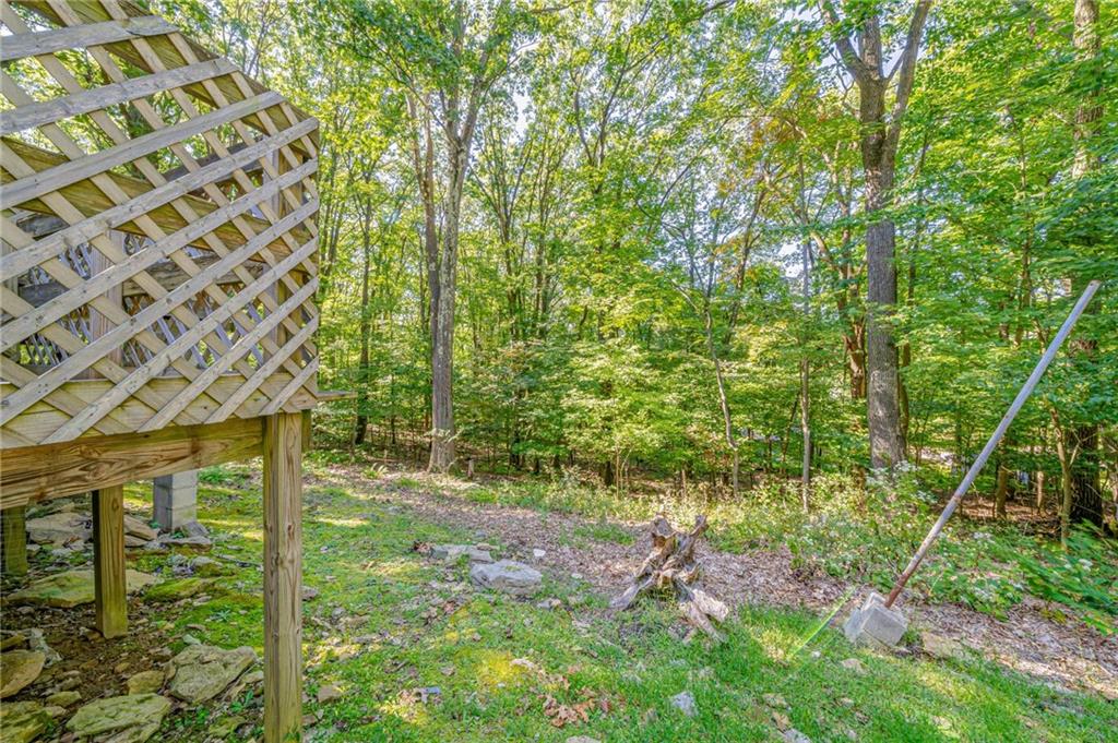 218 Horse Shoe Bend Road Acme, PA 15610 - Photo 23 of 31 a backyard of a house with lots of plants and seating space