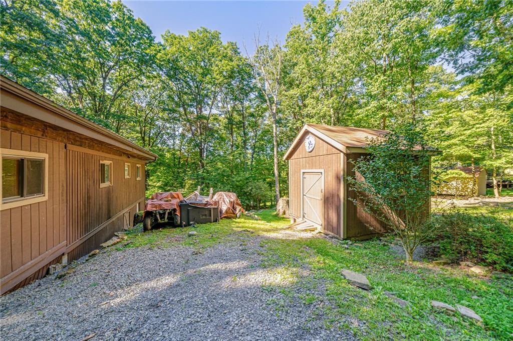 218 Horse Shoe Bend Road Acme, PA 15610 - Photo 25 of 31 a backyard of a house with yard and trampoline