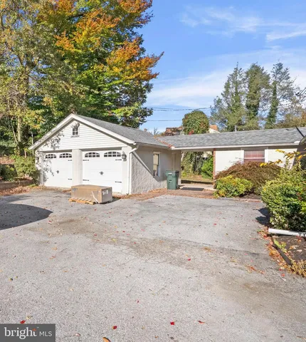 a view of a house with a yard and potted plants