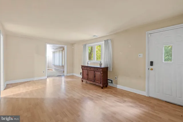 an empty room with windows and cabinet
