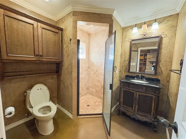 a bathroom with a toilet a sink and storage