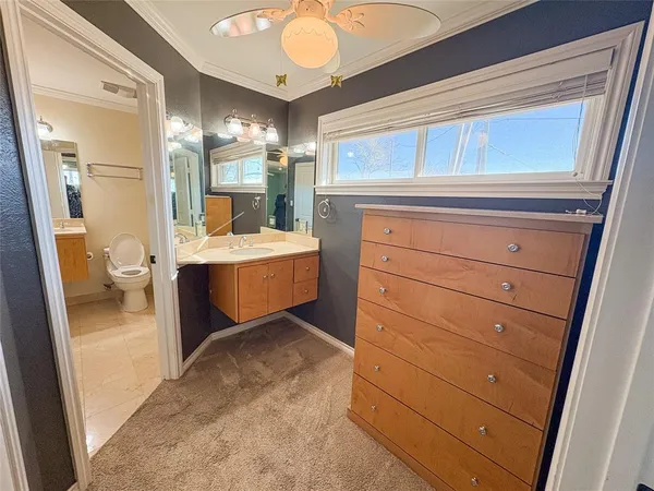 a room with a bed and a mirror on the dresser