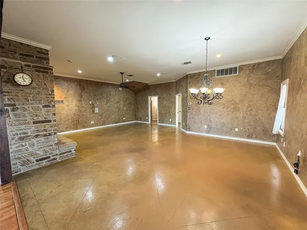 a view of an empty room with a chandelier