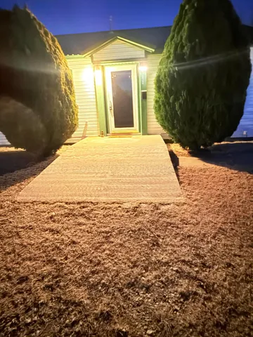 a living room with furniture a flat screen tv and a window