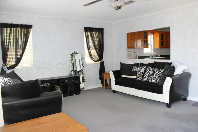 a living room with furniture a couch and a chandelier