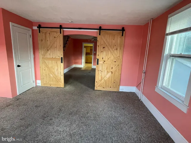 a view of room with window and entryway