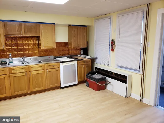 a kitchen with a stove sink and cabinets