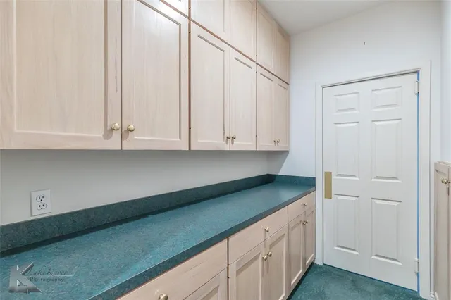 a kitchen with granite countertop white cabinets and sink