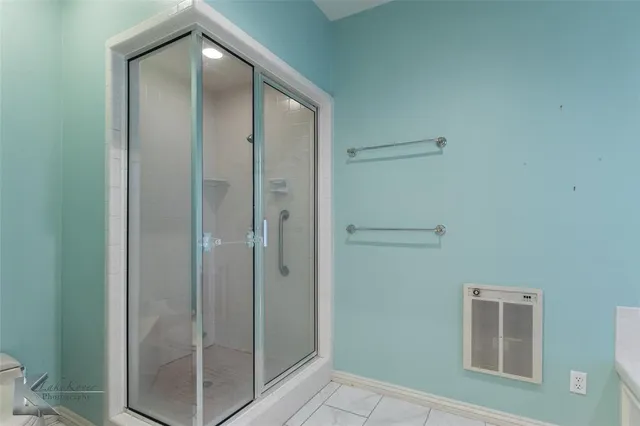 a bathroom with a bathtub and shower