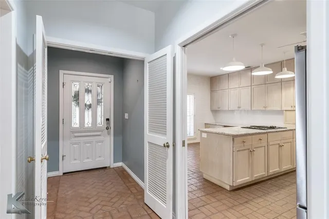 a kitchen with stainless steel appliances granite countertop a stove and a refrigerator