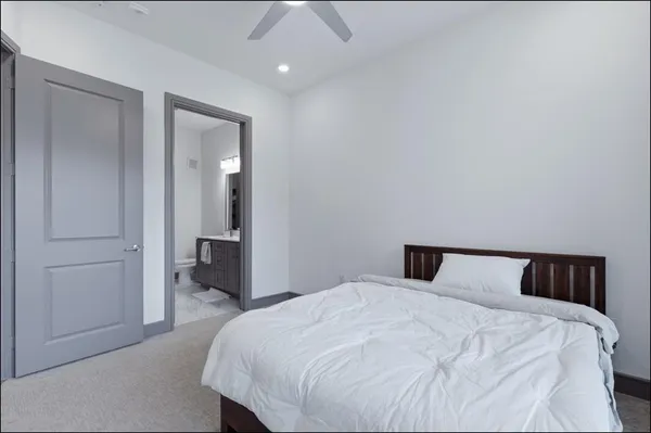 a bedroom with a bed and a mirror