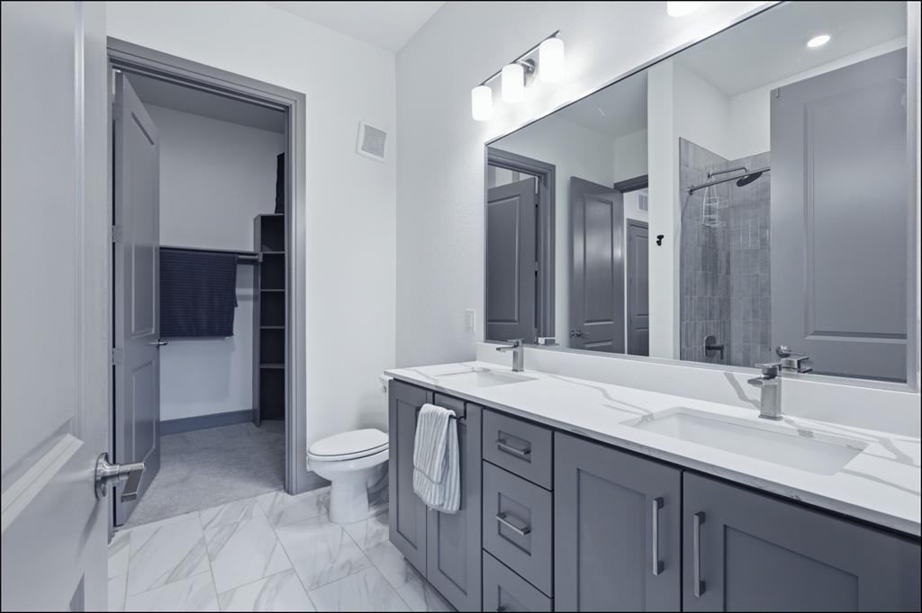 2700 Old Denton Road, Unit 2272 Carrollton, TX 75007 - Photo 12 of 40 a bathroom with a sink a toilet and shower