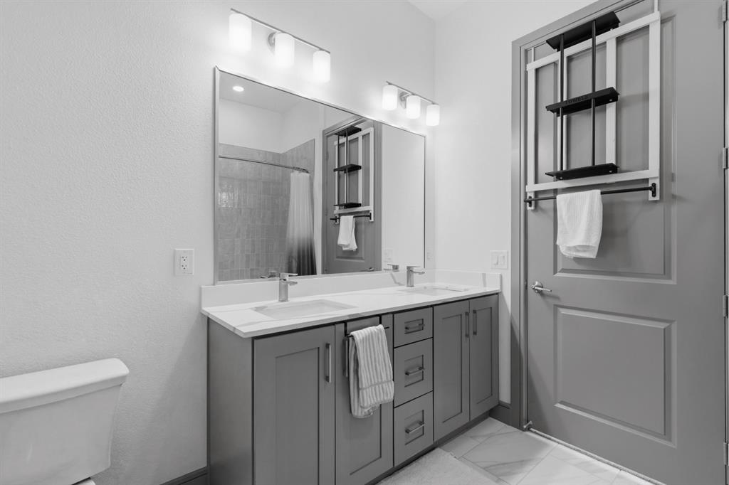 2700 Old Denton Road, Unit 2272 Carrollton, TX 75007 - Photo 13 of 40 a bathroom with a sink a toilet and shower
