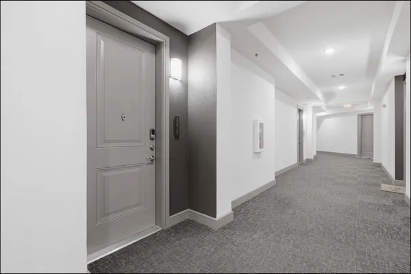 a view of a hallway with closet and wooden floor
