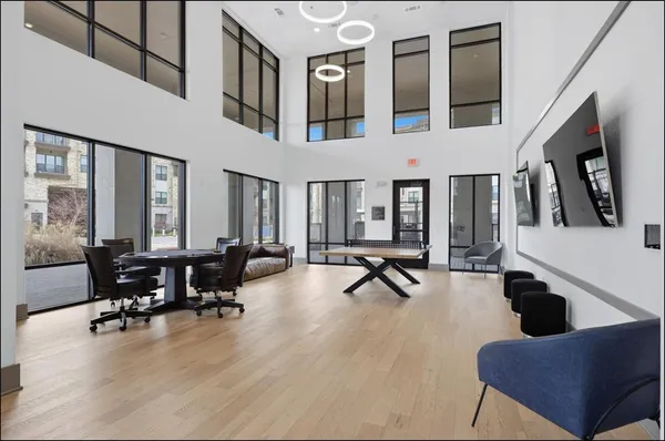 a living room with furniture gym equipment and a large window