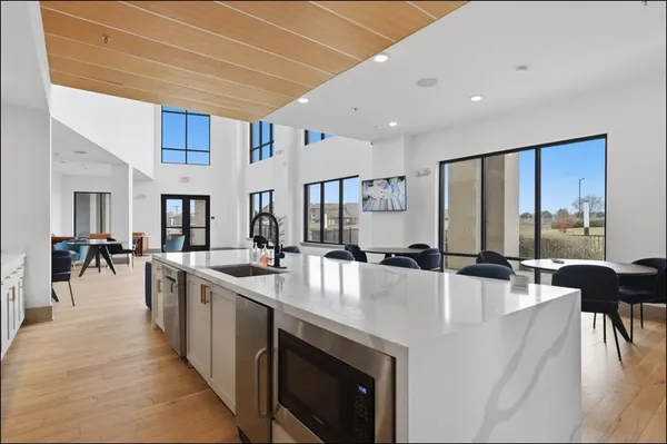 a living room with furniture a dining table and kitchen view