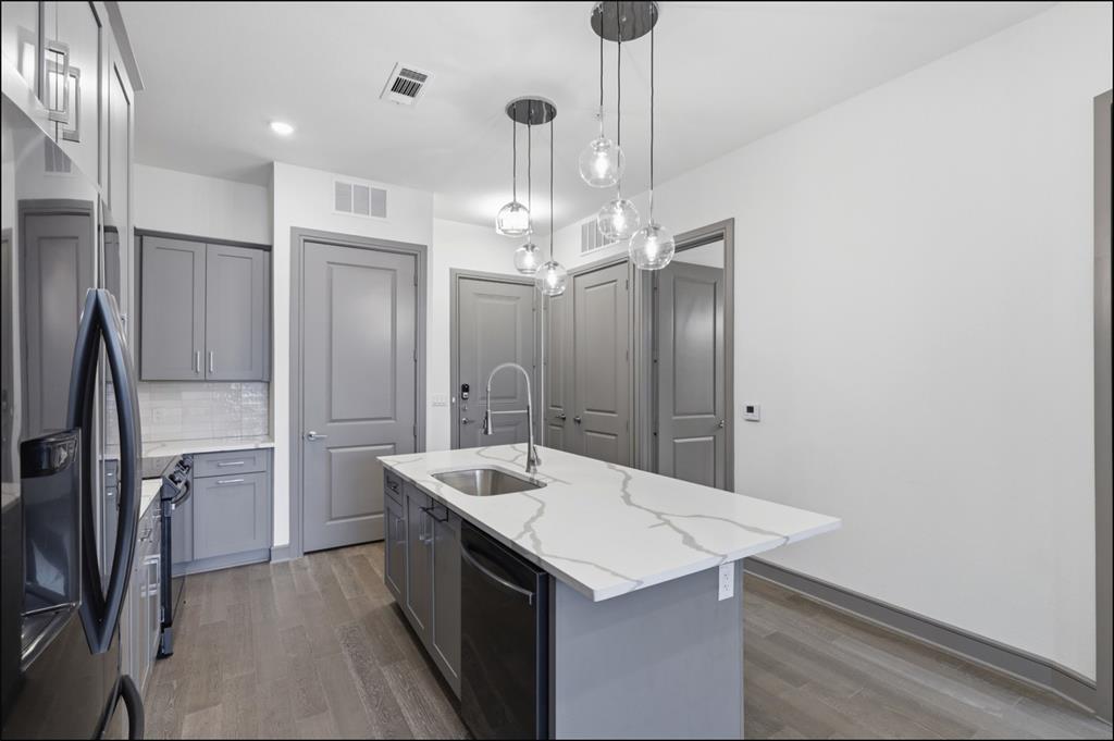 2700 Old Denton Road, Unit 2272 Carrollton, TX 75007 - Photo 3 of 40 a kitchen with a sink a counter space and stainless steel appliances