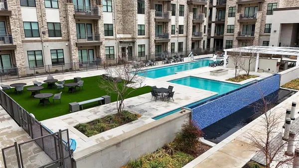 a view of a patio with swimming pool table and chairs