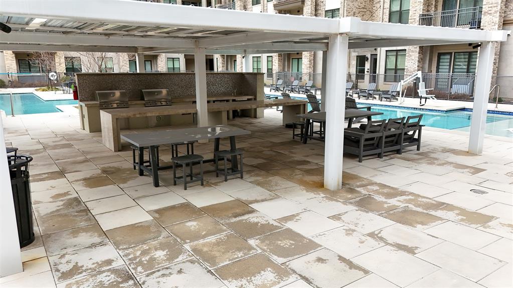 2700 Old Denton Road, Unit 2272 Carrollton, TX 75007 - Photo 37 of 40 a view of a patio with table and chairs near a barbeque