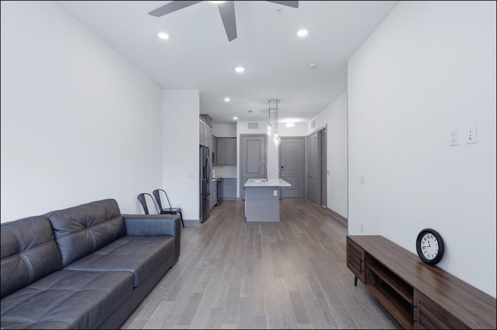 2700 Old Denton Road, Unit 2272 Carrollton, TX 75007 - Photo 7 of 40 a living room with furniture a table and kitchen view
