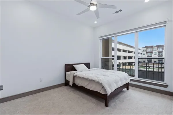 a bed sitting in a room next to a window
