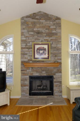 2135 Misty Meadow Road Finksburg, MD 21048 - Photo 2 of 27 a living room with a fireplace and a flat screen tv