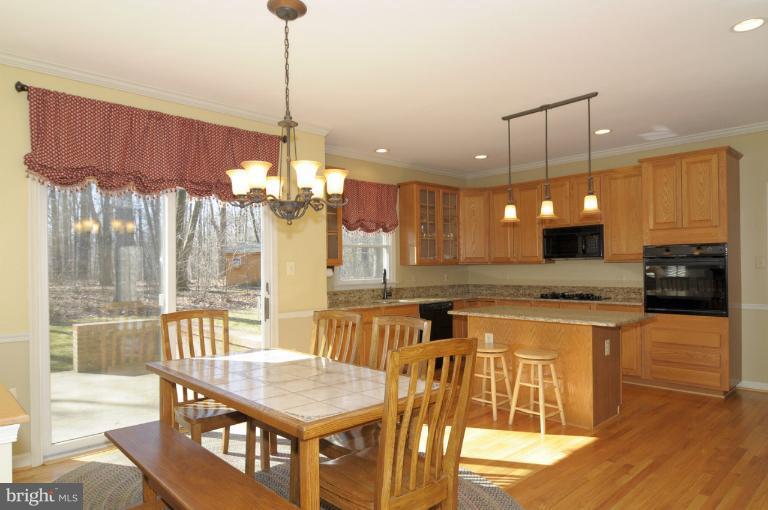2135 Misty Meadow Road Finksburg, MD 21048 - Photo 11 of 27 a kitchen with stainless steel appliances granite countertop a kitchen island and a refrigerator