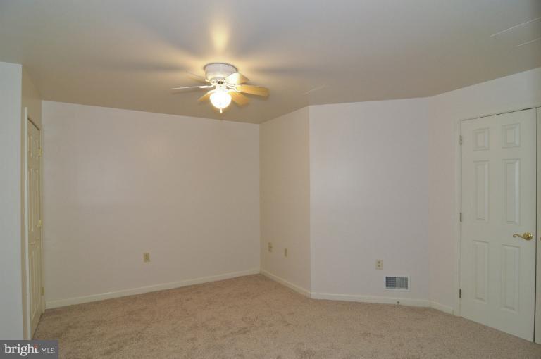 2135 Misty Meadow Road Finksburg, MD 21048 - Photo 13 of 27 an empty room with a chandelier fan and a ceiling fan