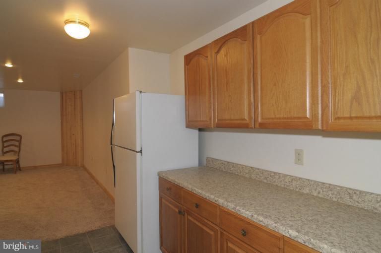 2135 Misty Meadow Road Finksburg, MD 21048 - Photo 14 of 27 a kitchen with a refrigerator and cabinets