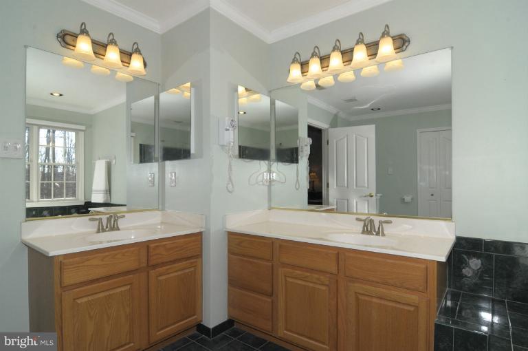 2135 Misty Meadow Road Finksburg, MD 21048 - Photo 4 of 27 a bathroom with a double vanity sink and a mirror