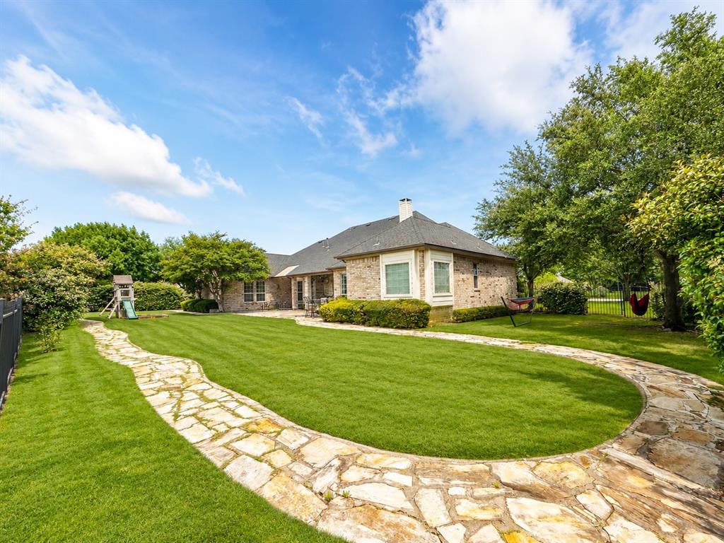 6004 Ridgemore Drive Parker, TX 75002 - Photo 9 of 13 a front view of a house with a yard table and seating