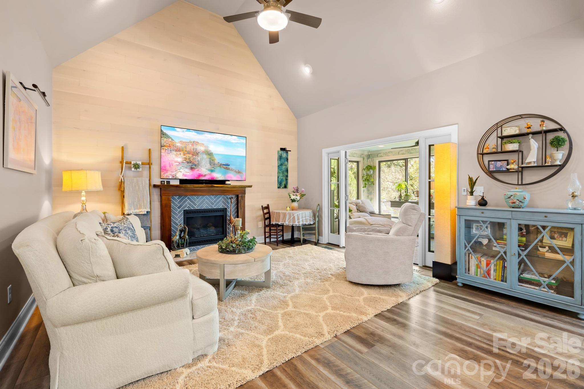 340 Riverwood Road Mooresville, NC 28117 - Photo 21 of 48 a living room with furniture a fireplace and a flat screen tv