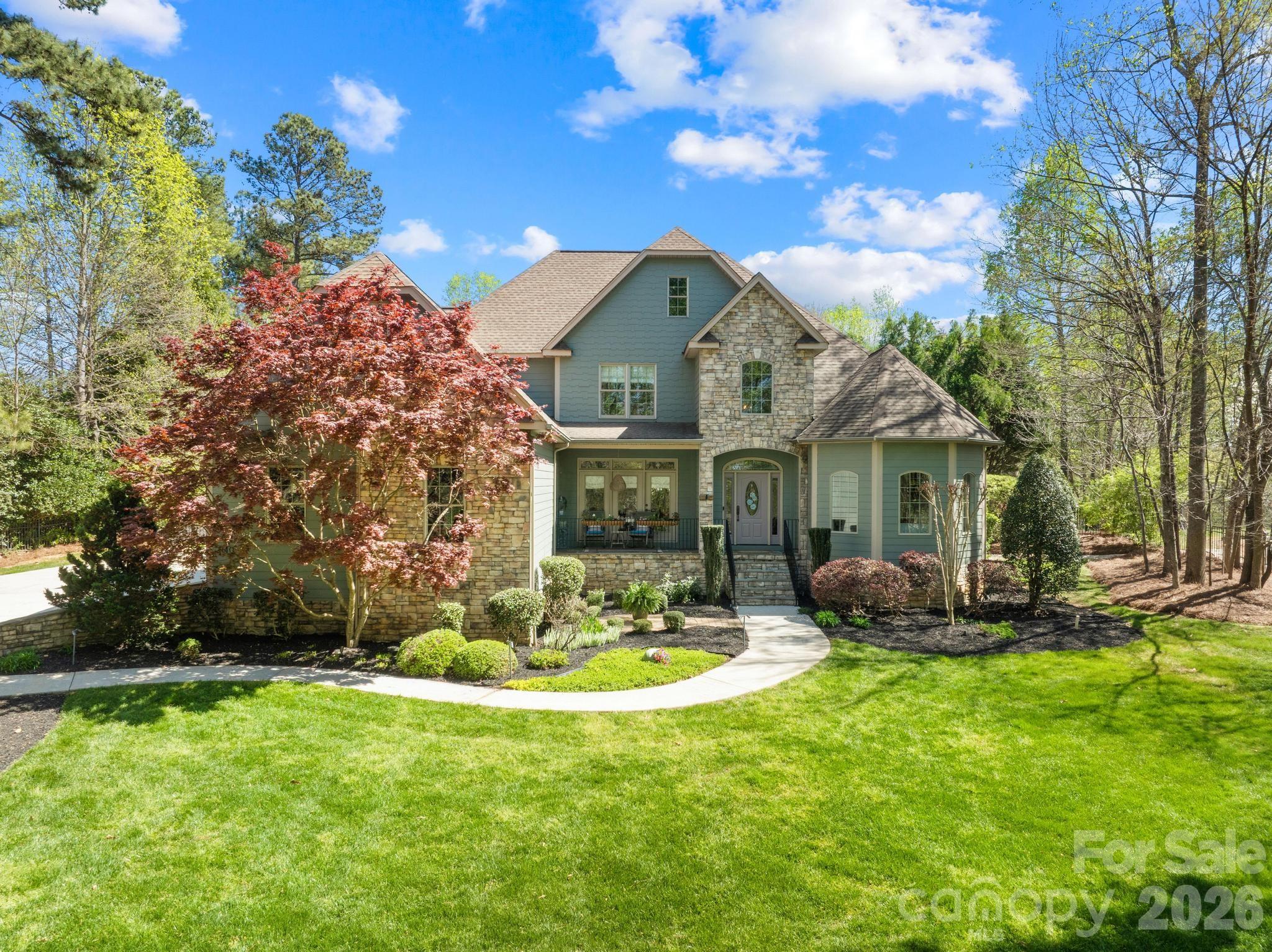 340 Riverwood Road Mooresville, NC 28117 - Photo 3 of 48 a front view of a house with garden