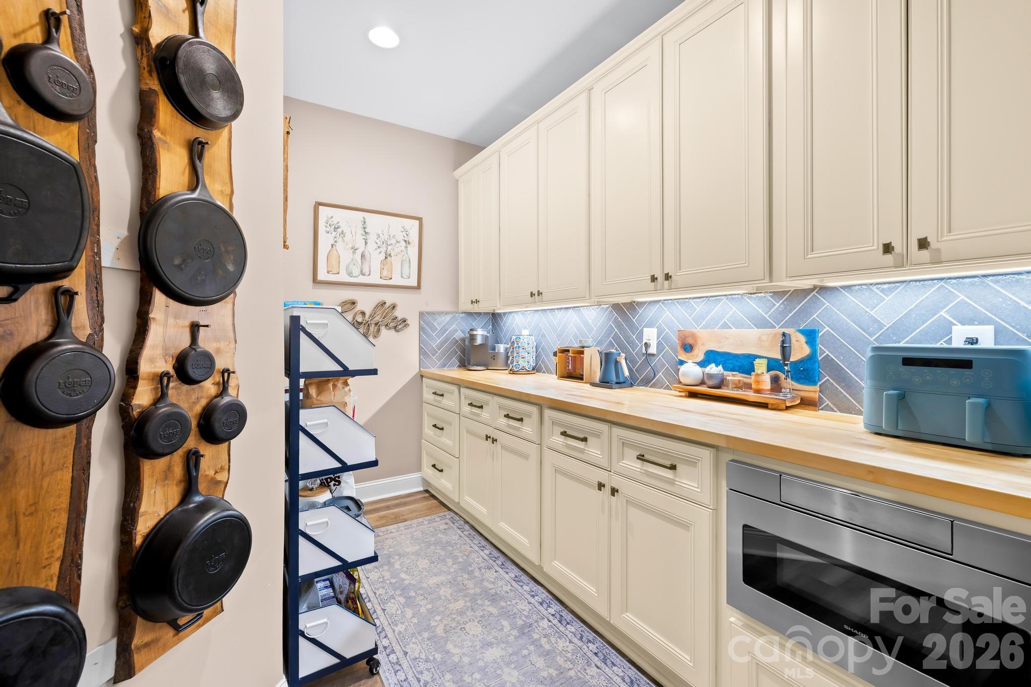 340 Riverwood Road Mooresville, NC 28117 - Photo 10 of 48 a kitchen with wooden cabinets and stove
